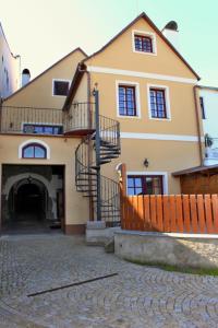 a large house with a staircase in front of it at Penzion Kasper Cyklopenzion in Jindrichuv Hradec