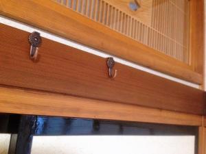 a wooden cabinet with two handles on a drawer at Midorian in Nikko