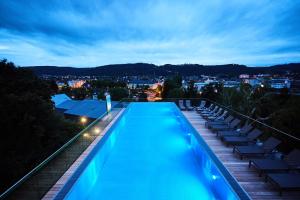 a swimming pool on the roof of a building at Hotel Villa Hügel in Trier