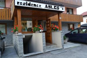 a building with a sign that reads kitties abies at Residence Ables in Valfurva