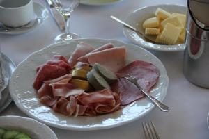 um prato de comida com carnes e queijo numa mesa em Gasthaus Eickholt Hotel-Restaurant em Ascheberg