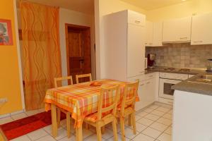 a kitchen with a table and chairs in a room at Ferienwohnung Kaufmann in Baiersbronn