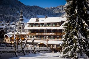 a hotel in the snow with a building at Hotel Christiania in La Clusaz