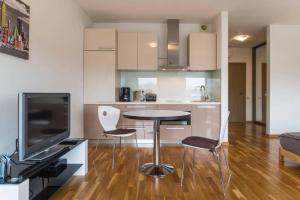 a kitchen with a table and chairs in a room at Riga Apartment in the Heart of City in Rīga