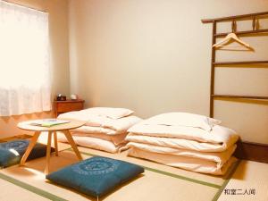 מיטה או מיטות בחדר ב-Guesthouse Kyoto Arashiyama