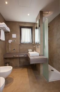 a bathroom with a sink and a mirror at Best Western Plus Borgolecco Hotel in Arcore