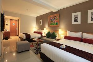 Una cama o camas en una habitación de Ivory Hotel Bandung