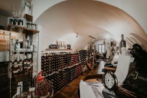 a room filled with lots of bottles of wine at Penzion Víno Hruška Pardubice in Pardubice