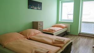 A bed or beds in a room at Apartmány ORAVA-EDDA