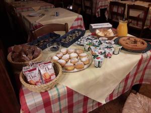 a table with baskets of bread and pastries on it at B&B da Toi in Marostica