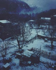 a black and white photo of a yard covered in snow at Orchards House - The Hidden Tribe in Manāli