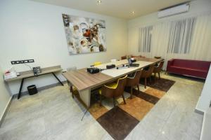 a conference room with a large table and chairs at The Palms by Eagles Accra in Accra