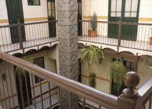 a balcony of a building with potted plants at Hotel Naira in La Paz