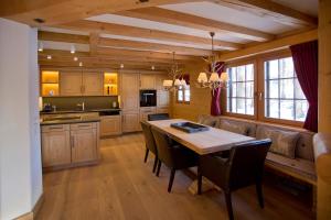 een keuken met een tafel en stoelen en een bank bij Chalet Chesa Surlej, Davos in Davos