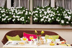 a table with food and drinks and flowers on it at Hotel & Restaurant Sonne in Kirchzarten