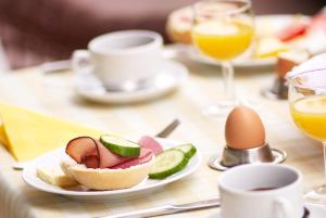 a table with a plate of food and an egg at Hotel & Restaurant Sonne in Kirchzarten