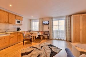 a kitchen with a table and a dining room at Pension Regina in Lech am Arlberg