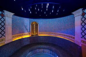 a building with a blue tiled wall with a window at Papuga Park Hotel Wellness Marrakesz & SPA in Bielsko-Biala