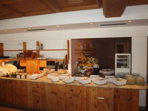 a kitchen with a counter with food on it at Sporthotel Rasen in Rasùn di Sotto