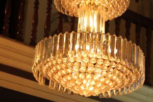 a large glass chandelier hanging from a railing at ShivalayaHomestay in Trichūr