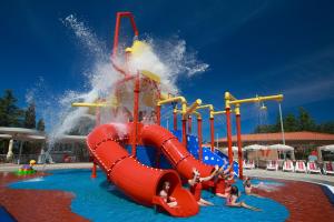 a water slide at a water park with people on it at Hotel Garden Istra Plava Laguna in Umag