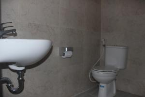 a bathroom with a sink and a toilet at Adi Bali Homestay in Uluwatu