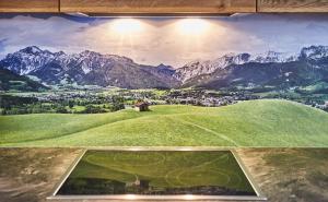 un dipinto di un campo da calcio su una collina verde di Holiday Penthouse Moosweg a Maishofen