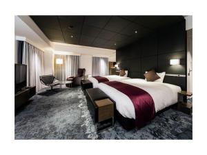 מיטה או מיטות בחדר ב-Daiwa Roynet Hotel Ginza PREMIER