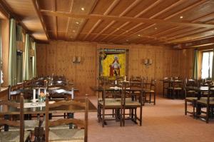 a dining room with wooden tables and chairs at Gasthaus Skiklub in Andermatt