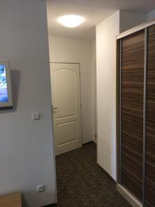 an empty room with a door and a hallway at Penzion 103 in Železná Ruda