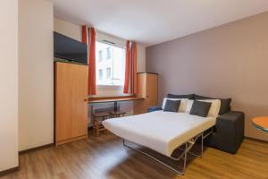 Ein Bett oder Betten in einem Zimmer der Unterkunft City Residence Access Strasbourg