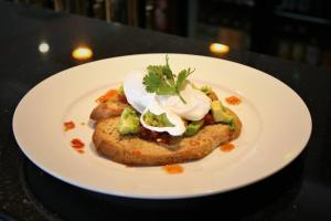 a white plate with a piece of food on a table at Shipquay Boutique Hotel in Derry Londonderry