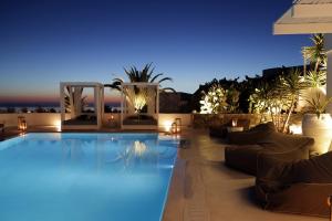 a swimming pool at night with lights at Livin Mykonos Hotel - Adults Only in Mýkonos City