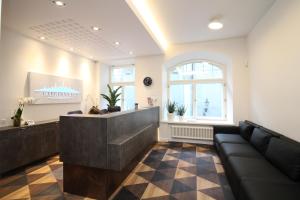 a lobby with a reception desk and a couch at Tallinn City Apartments Old Town Suites in Tallinn