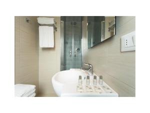 a bathroom with a white sink and a mirror at Hotel Gardenia in Lido di Jesolo