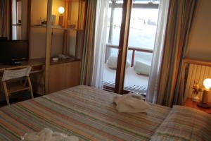 a hotel room with a bed with towels on it at Il Fraitevino hotel bed & breakfast in Sestriere