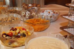 una mesa cubierta con tazones de fruta y otros alimentos en Jugendgästehaus St. Gilgen, en Sankt Gilgen