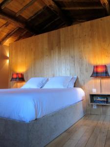 a bedroom with a bed with two lamps on it at Casa do Talasnal in Lousã