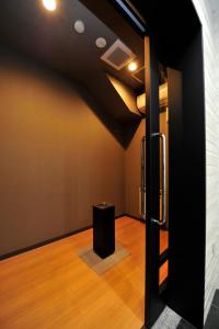 a room with a black door and a black stool at Hotel JIN Morioka Ekimae in Morioka