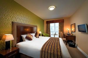 Tempat tidur dalam kamar di George Limerick Hotel