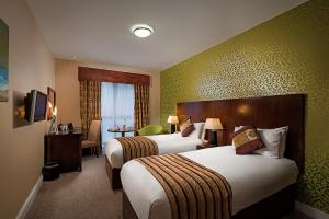 Tempat tidur dalam kamar di George Limerick Hotel