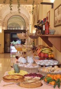 a buffet of fruits and vegetables on a table at Hotel Adria in Bari