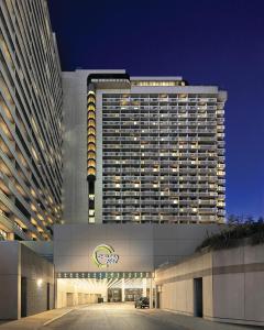 a large hotel building with a parking lot in front of it at Chelsea Hotel Toronto in Toronto