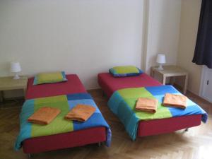 two beds in a room with towels on them at Ragtime in Prague