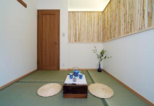 a room with a table and two chairs and a door at Lucy's House横浜中華街 House1 in Yokohama