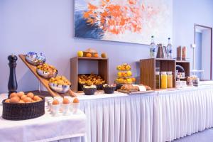 a buffet with oranges and other food on a table at Hotel Sagitta in Geneva