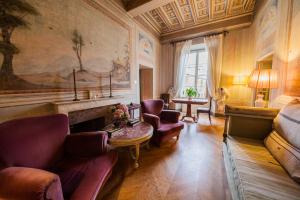 een woonkamer met een bank en een open haard bij Palazzo Rocchi - Residenza D'Epoca in Lucca