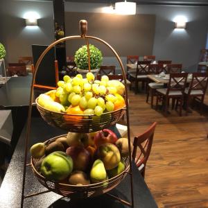 two baskets of fruit on a table in a restaurant at Park Hotel Airport in Charleroi