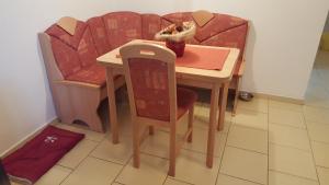 a small table with chairs and a table and a table and chairs at Apartmán Srní in Srní