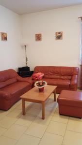 a living room with two couches and a coffee table at Apartmán Srní in Srní